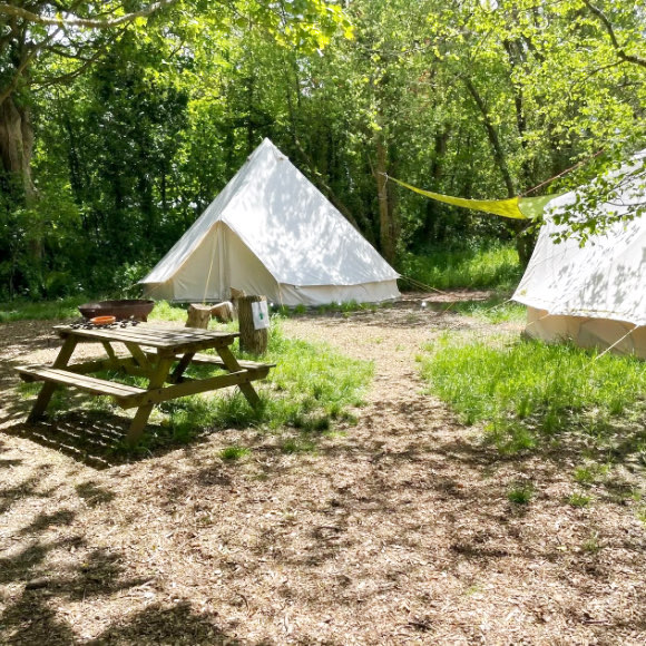 Bell tent glampimg in woodlands at Penhallow Hpouse Retreat near Newquay, Cornwall.